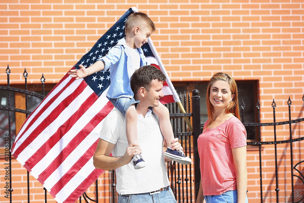 Happy family with American flag in the yard