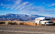 American panorama. Pick-up wehicle with horse trailer on rocky background