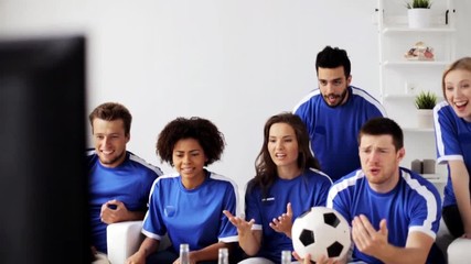 Wall Mural - friends or football fans watching soccer at home