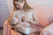 Close-up portrait mother breastfeeding her baby with breast milk