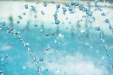 Fototapeta Dmuchawce - water drops in the air. Blurred soft abstract background. drop fountain.
