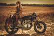 © Nejron Photo - Stylish woman on the vintage custom cafe racer in a field.
