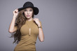 © dorriss - Beautiful woman with long hair in a brown dress and black hat