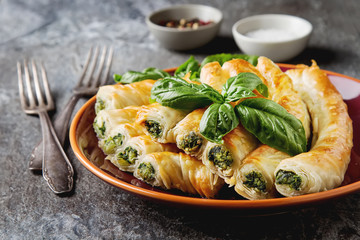 Traditional homemade Greek cheese, spinach pie on a red plate. G