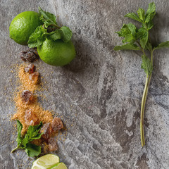 Wall Mural - Ingredients for mojito. Fresh mint, limes, sugar over black back