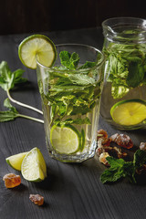 Wall Mural - Mint iced tea with lime in the glass. Dark background.