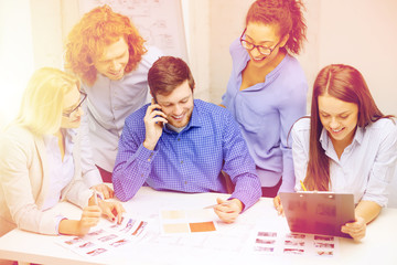 Poster - creative team with papers and clipboard at office