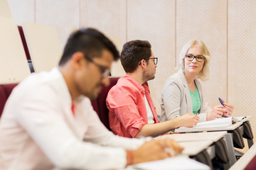 Canvas Print - group of students with notebooks in lecture hall