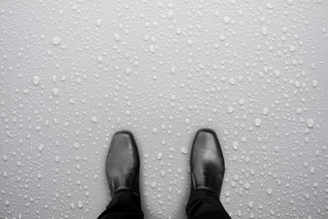 Wall Mural - Black shoes standing on white wet floor