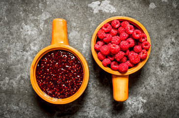 Two bowl with jam and forest berries raspberry.