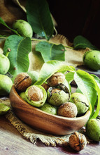 Fresh Walnuts In A Green Shell With Leaf, Vintage Wooden Backgro