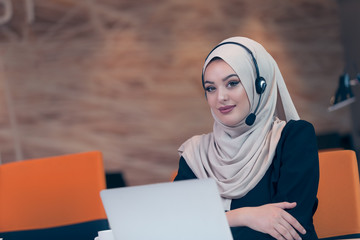 Wall Mural - Beautiful phone operator arab woman working in startup office