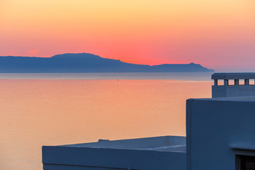 sunset over the mountain with reflection on the sea