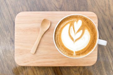 Cup of coffee latte art on wood table