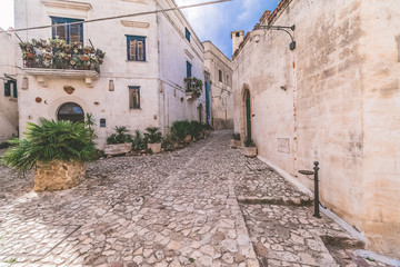 typical old street view of Matera under blue sky