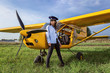 On a green field Girl in ultralight aircraft.