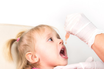 The little girl on reception at the doctor receives the polio va