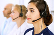 © rogerphoto - Call center. Focus on beautiful woman in headset