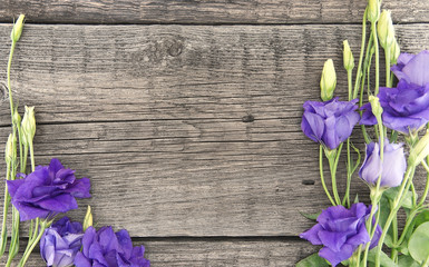 Wall Mural - Bouquet of purple flower lisianthus on rustic wooden background