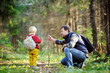 © Maria Sbytova - Father and his son walking during the hiking activities in forest
