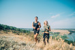 © kurapatka - Young couple running outdoor. Male and female jogging in the countryside near the lake