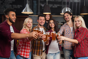 Wall Mural - Young People Group In Bar Toasting, Hold Beer Glasses, Friends Cheers Standing At Pub,  Happy Smiling