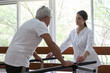 © implementarfilms - Adult doing a physical rehabilitation in a parallel bars
