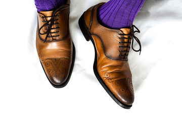 Brown shoes, purple socks