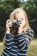 © luckykot - Cute little girl with a vintage rangefinder camera.