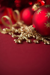 Wall Mural - red and golden christmas ornaments on red xmas background with copy space