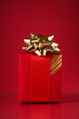 Wall Mural - red gift box on red background. merry christmas card. winter holidays. xmas. valentine's day.