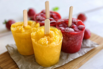 Tasty fruit ice-cream on cutting board