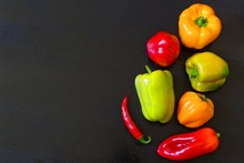 A Variety Of Peppers On A Dark Background