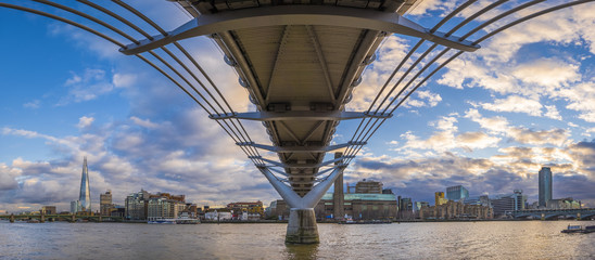 Wall Mural - Panoramic skyline taken under the Millennium Bridge at sunset with beautiful sky and clouds - London, UK