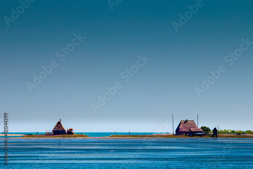Fotomural tipici casoni, laguna di Marano, Italy