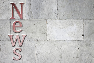 Fototapete - News carved on white stone wall