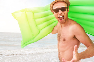 Wall Mural - Happy man with swimming mattress