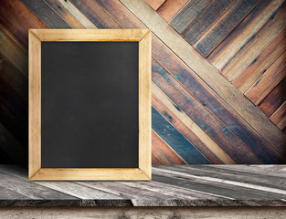 Blank blackboard on wooden table top at diagonal tropical wood w