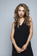 © aporubaymykh - Stylish beautiful girl in a black dress in the studio isolated.