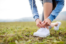 Close Up Of An Unrecognizable Young Runner Tying Shoelaces