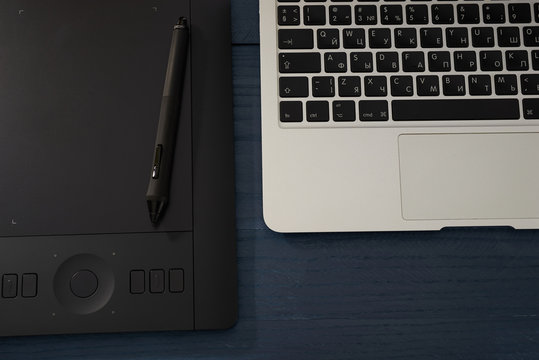 black handle, professional graphic tablet and laptop