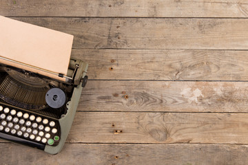 Fototapete - Vintage typewriter on the old wooden desk