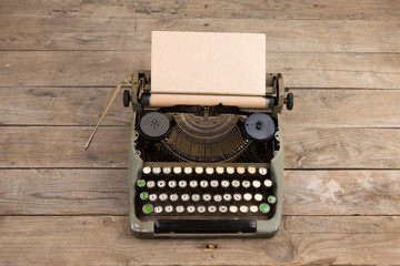 Fototapete - Vintage typewriter on the old wooden desk