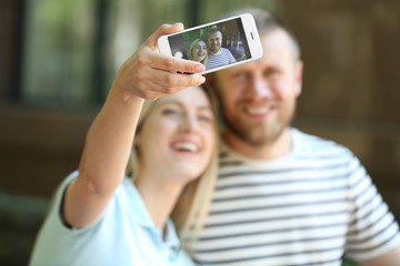 Poster - Happy couple taking selfie on the street