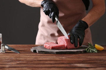Wall Mural - Butcher cutting pork meat on kitchen