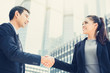 © Atstock Productions - Businesswoman making handshake with a businessman