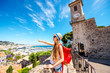 Young female traveler enjoying great view on Cannes city from the castle hill in France