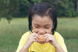 © weerajata - Cute girl is eating bread. Tasty bread makes her happy.