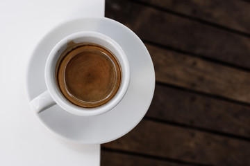 Cup of coffee espresso on a wooden background