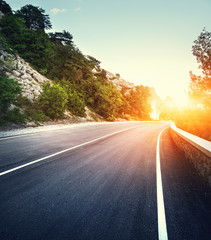 Wall Mural - asphalt road with instagram toning. landscape with mountain road with a perfect asphalt at sunset in